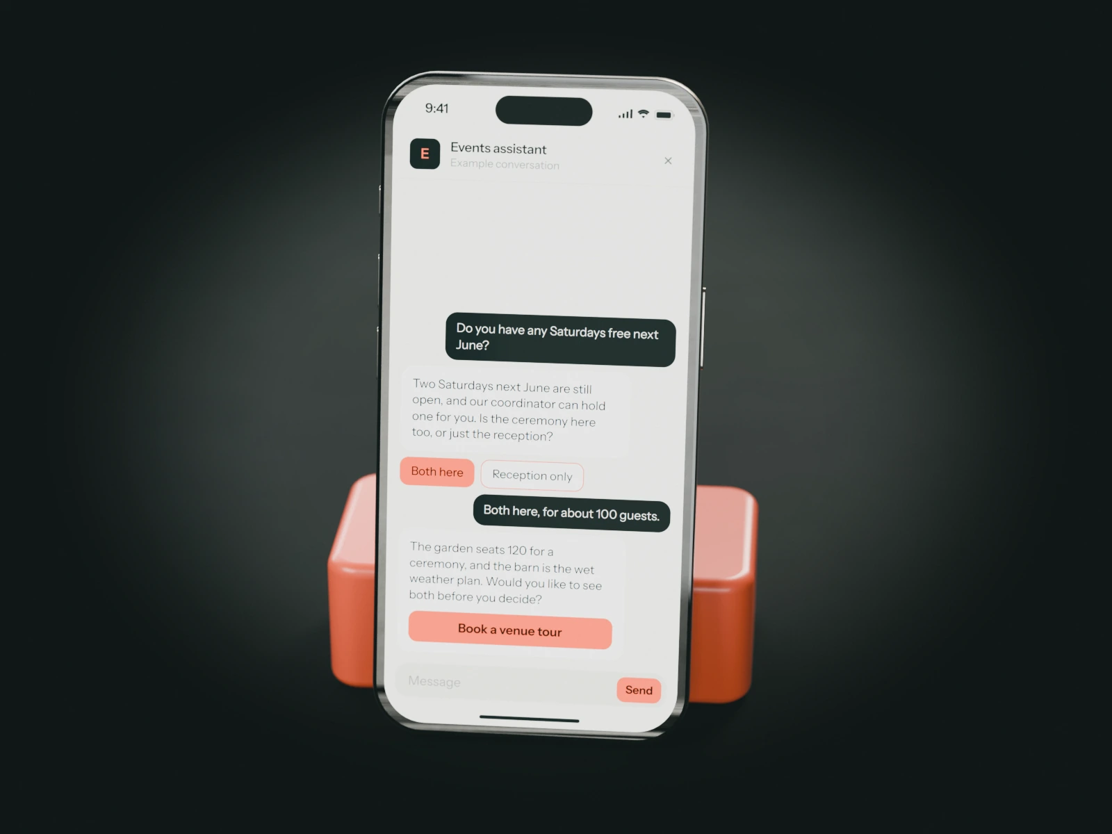 A phone on a coral stand showing an example chat with a wedding venue's events assistant: a couple asks about Saturdays next June and is offered a venue tour.