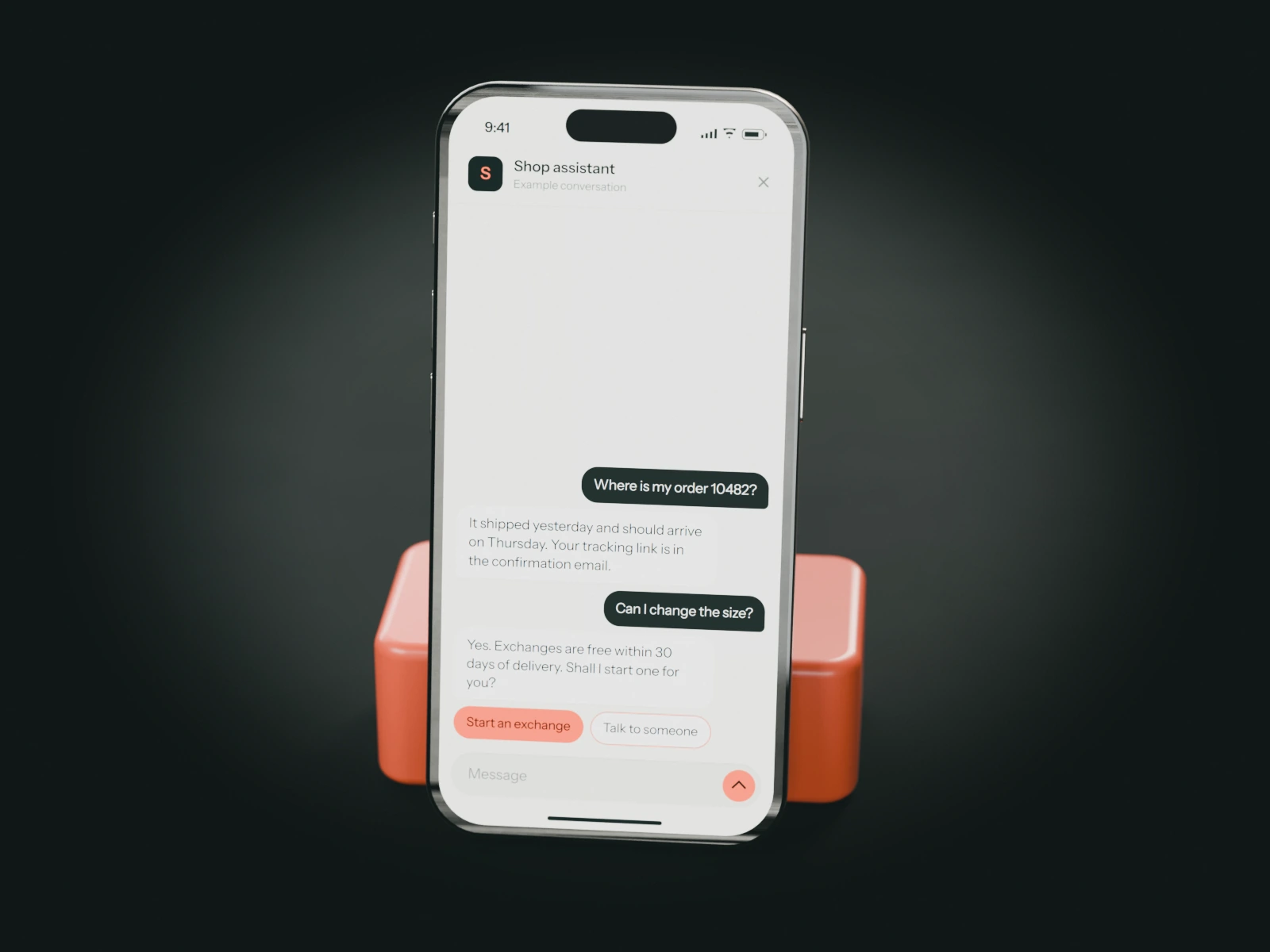 A phone on a coral stand showing an example chat with an online store's assistant: a customer checks an order and asks to exchange the size.