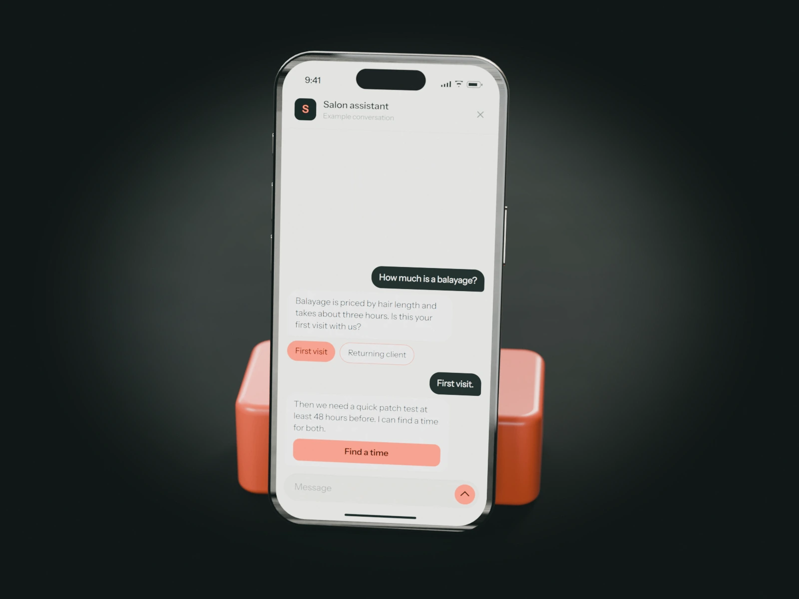 A phone on a coral stand showing an example chat with a salon's assistant: a new client asks about balayage and is told about the patch test.
