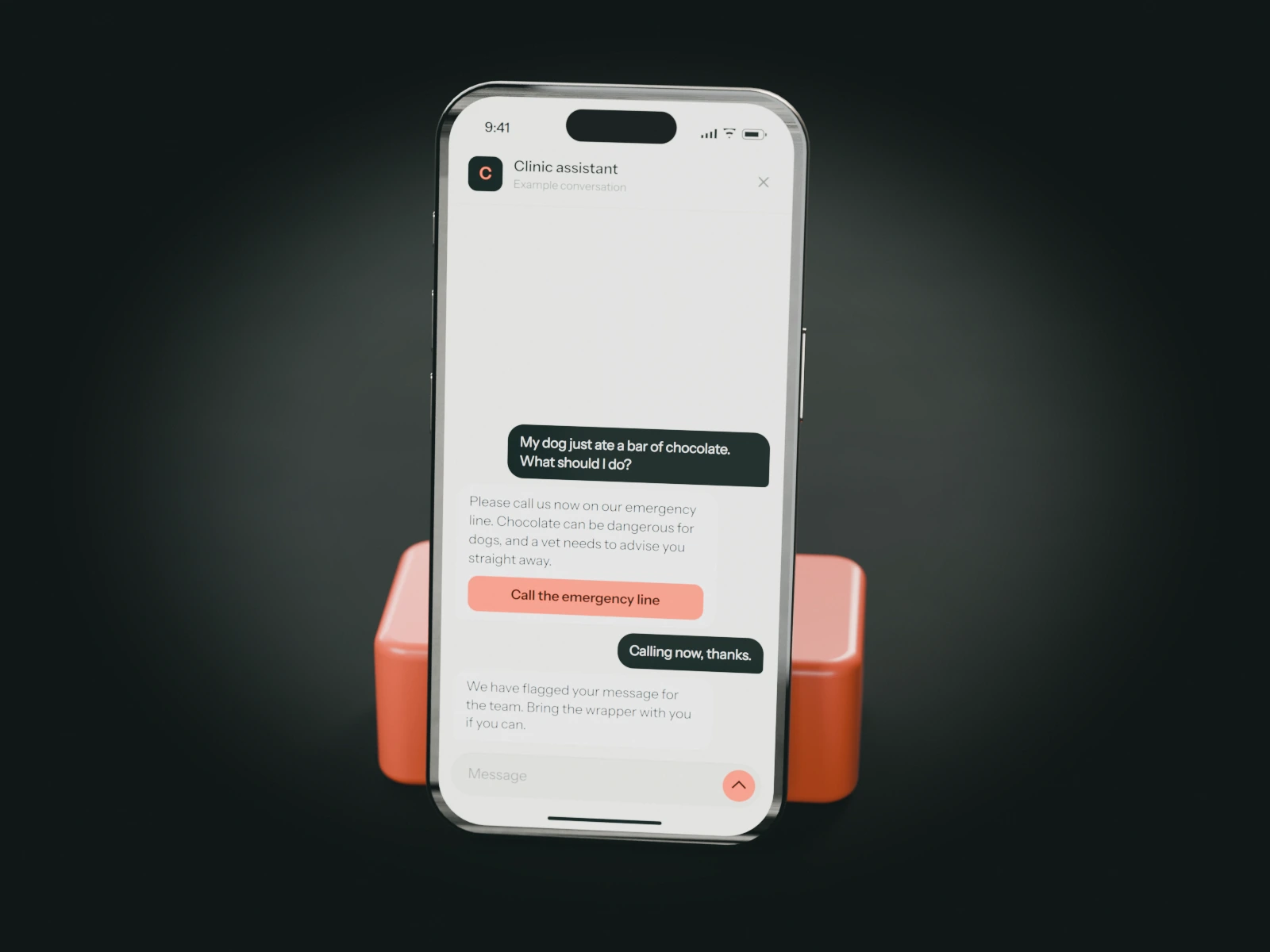 A phone on a coral stand showing an example chat with a veterinary clinic's assistant: an owner whose dog ate chocolate is told to call the emergency line now.